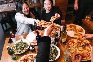 11 Inch Pizza - Group eating pizza - pizza cheers