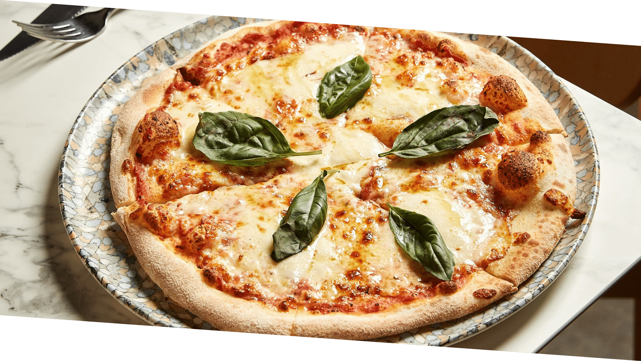 Classic Margherita pizza topped with basil and mozzarella at 11 Inch Pizza Melbourne.
