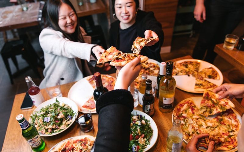 11 Inch Pizza - Group eating pizza - pizza cheers