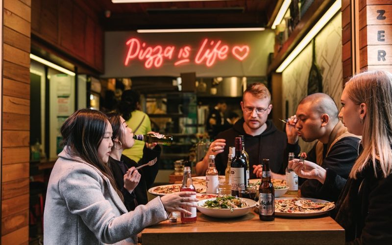 11 Inch Pizza - Group eating pizza