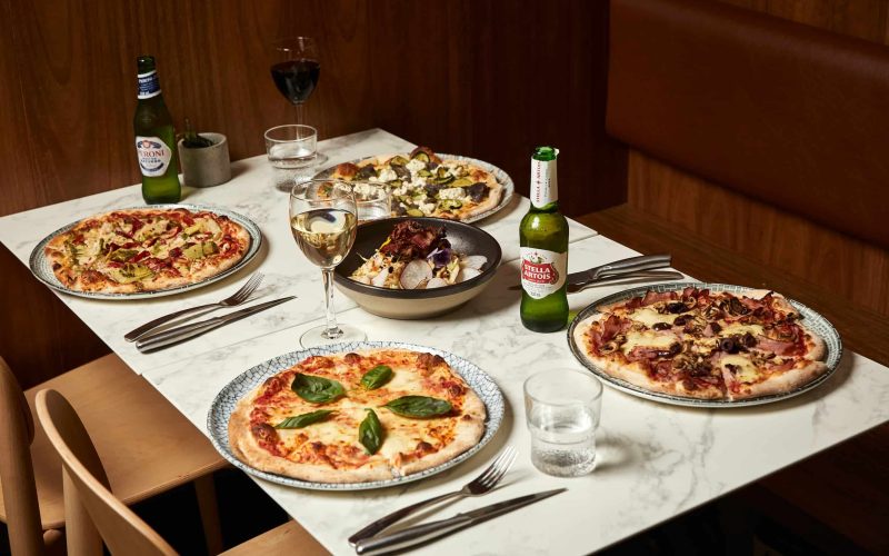 Delicious gourmet pizzas, fresh salad and drinks at 11 Inch Pizza—dine in or order online for a tasty treat.